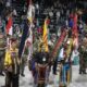 8 Indigenous people gather together and present flags and eagle staphs to be honored at a Pow Wow Grand Entry Ceremony in Minnesota.